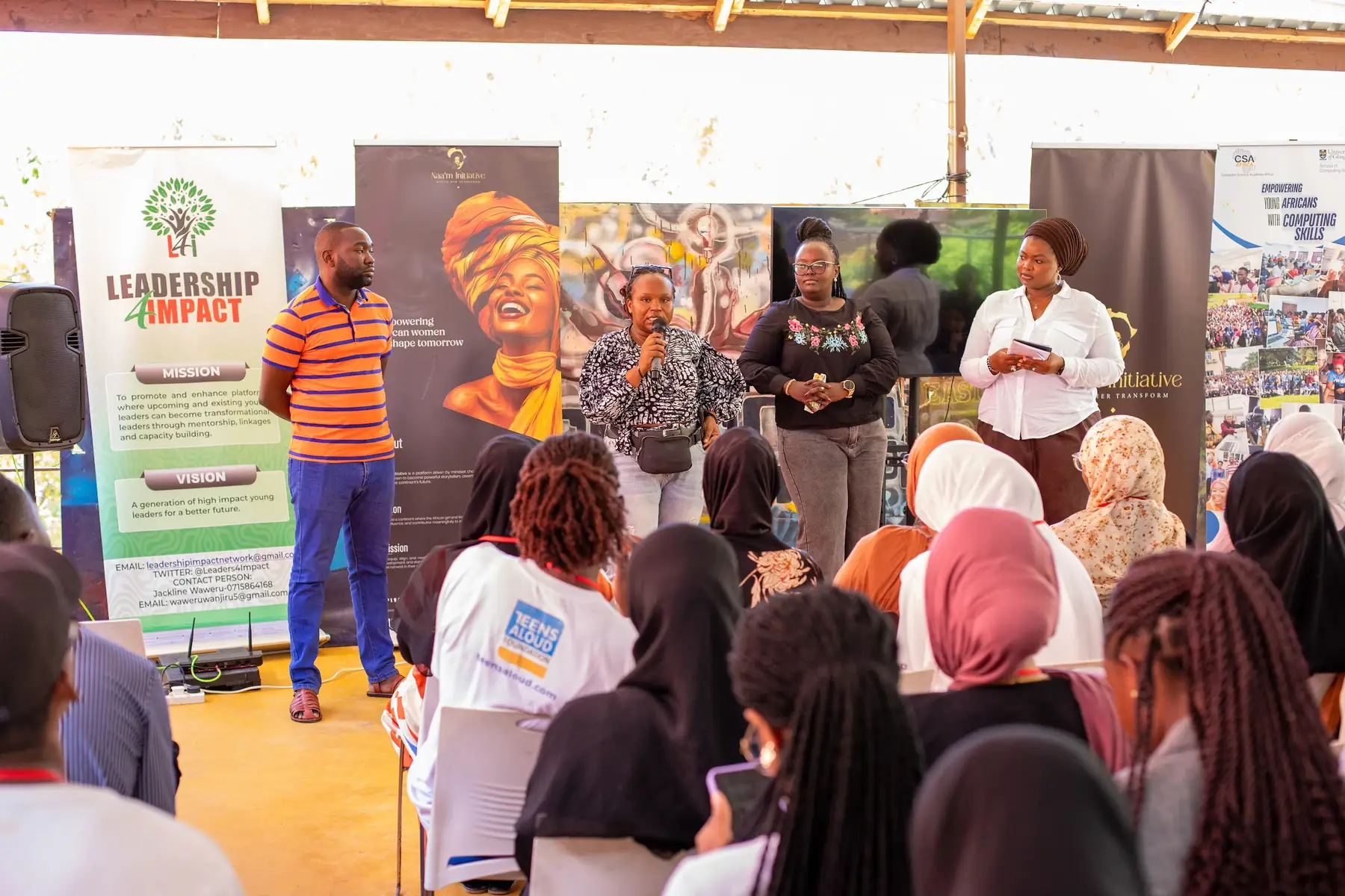 A facilitator speaking to participants standing in the room