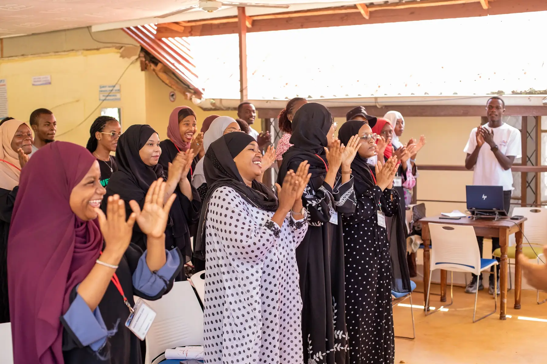 Participants applauding at the close of a session
