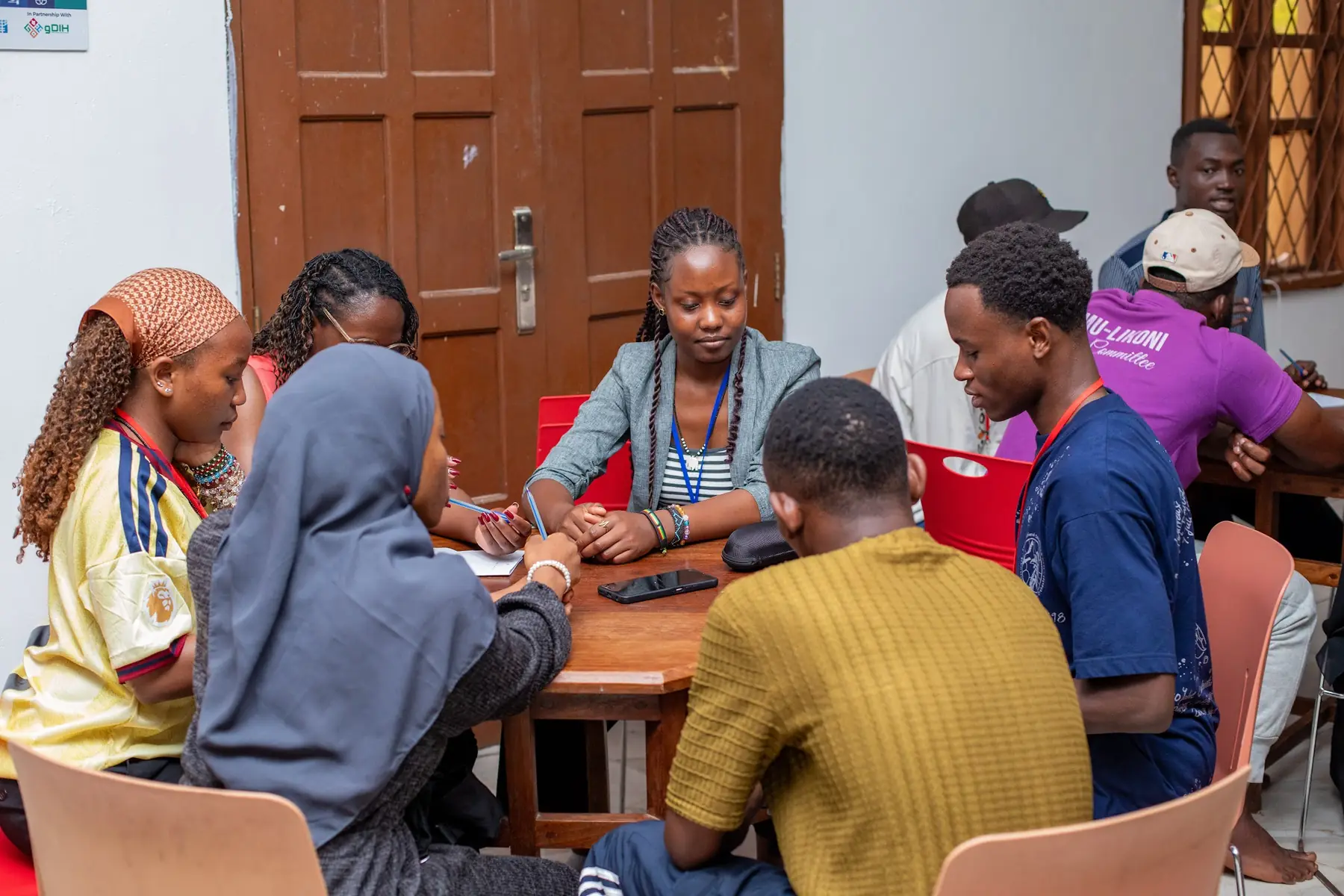 Participants working together around a table at INUKA Mombasa